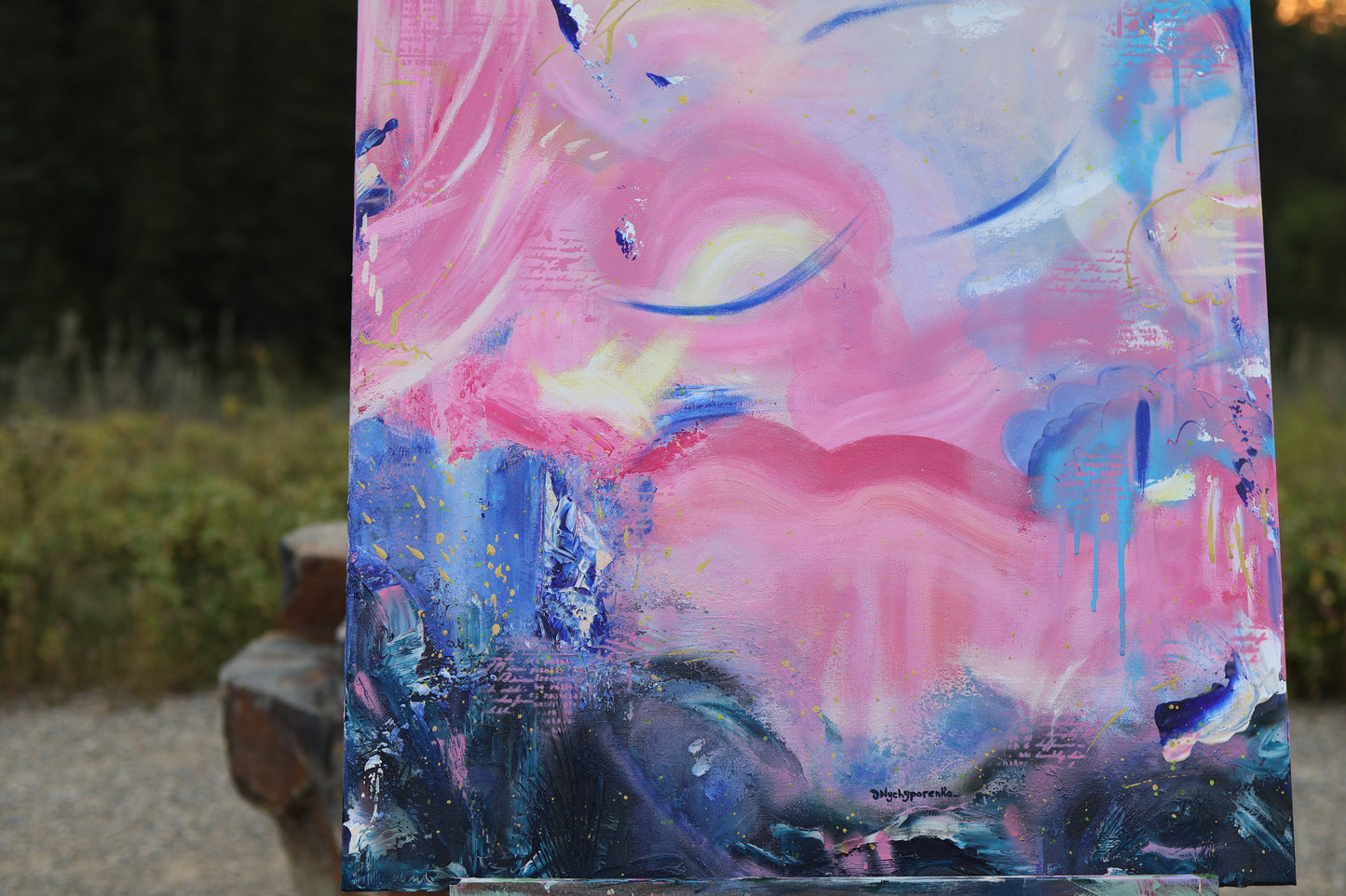 Abstract acrylic painting in vibrant pink, blue, and purple tones with flowing textures and cosmic details. Artwork by Olia Nychyporenko, 24x24 inches, part of the series 'I Arrived as Feeling'.