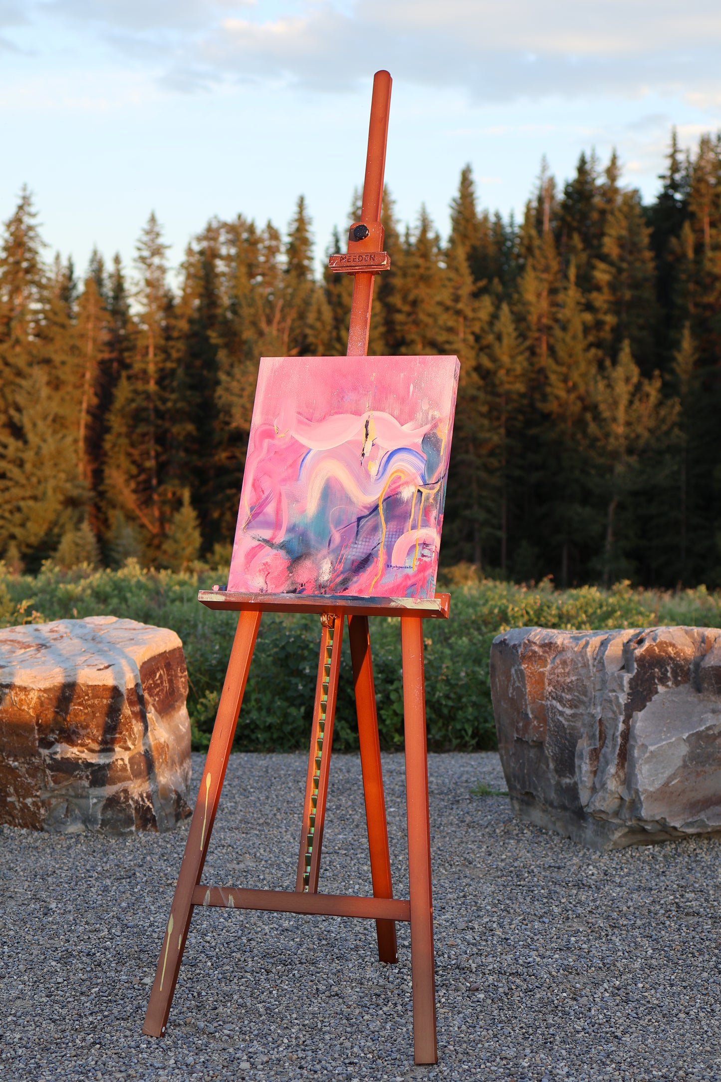“I Took Space, Finally” – original abstract acrylic painting by Olia Nychyporenko (artbyOliaN), displayed on an easel outdoors. Textured artwork in vivid pinks, purples, and deep blue, expressing movement and release.