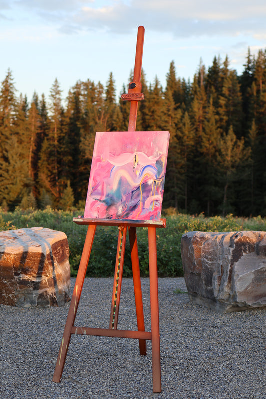 “I Took Space, Finally” – original abstract acrylic painting by Olia Nychyporenko (artbyOliaN), displayed on an easel outdoors. Textured artwork in vivid pinks, purples, and deep blue, expressing movement and release.