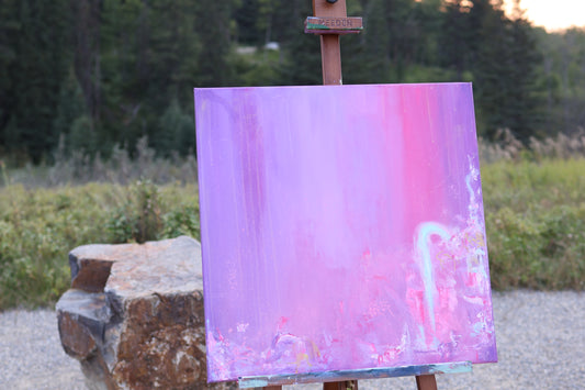 Original abstract painting “Violet Touch” – 24x24 acrylic on thin gallery-wrapped canvas, featuring soft violet and pink tones with textured details, displayed outdoors on an easel.